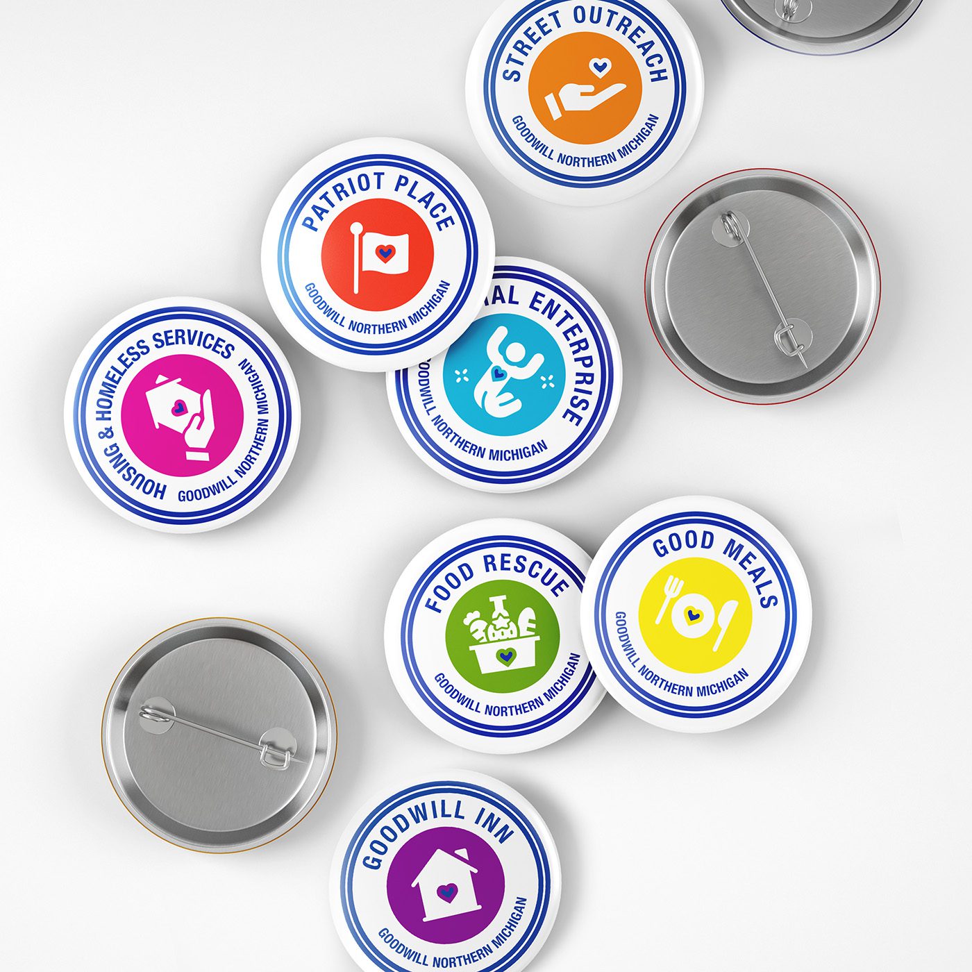 small button badges designed to represent the individual programs of GoodwillNMI