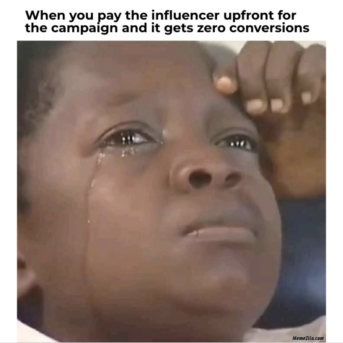 Closeup of young kid crying and contemplating meme with text "When you pay the influencer upfront and it gets zero conversions."